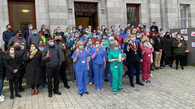 Staff at Covid-19 vaccination centre at City Hall, Cork, light candles and remember Ashling Murphy