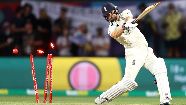 England's Mark Wood is bowled by Pat Cummins of Australia