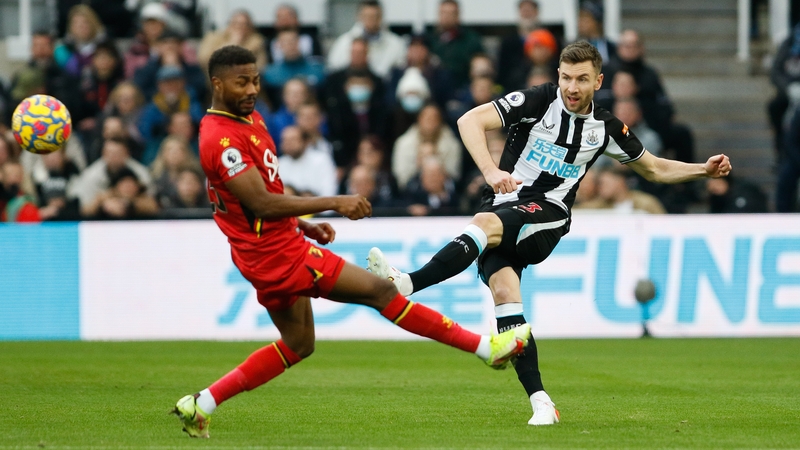 Paul Dummett of Newcastle United and Emmanuel Dennis of Watford