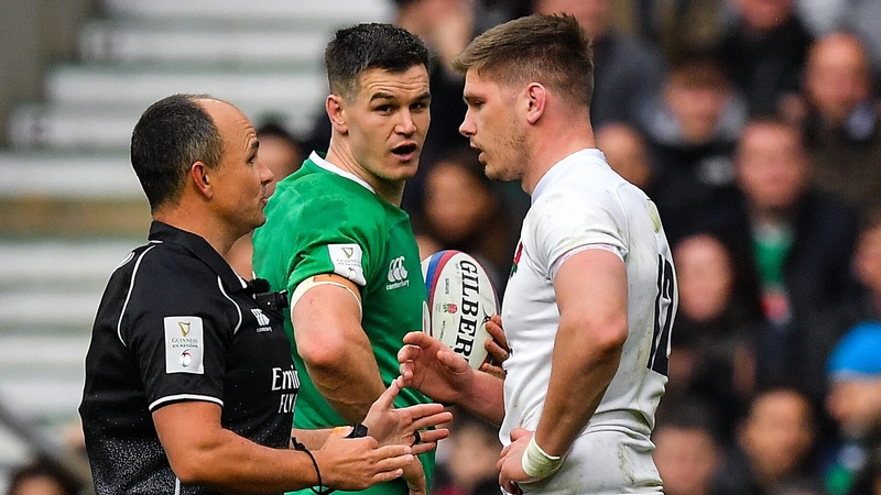 Jaco Peyper talks to Owen Farrell as Johnny Sexton looks on