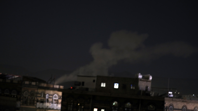 Dust and smoke billow above a neighborhood following Saudi-UAE-led airstrikes in Sana'a, Yemen