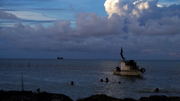 This image taken in December shows white gaseous clouds rising from the Hunga Ha'apai eruption seen from the Patangata coastline near the Tongan capital