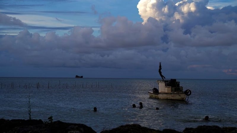 This image taken in December shows white gaseous clouds rising from the Hunga Ha'apai eruption seen from the Patangata coastline near the Tongan capital