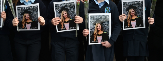 Pupils from Ashling Murphy's class formed a guard of honour - and held photographs and red roses