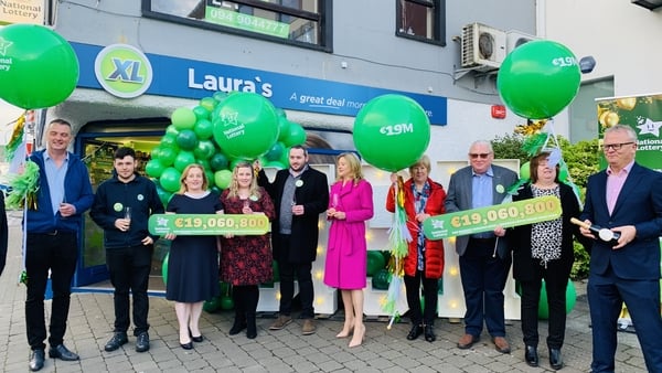 Laura Scriney celebrates selling the winning jackpot ticket