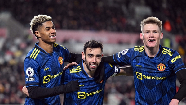 Marcus Rashford celebrates scoring his team's third goal with Bruno Fernandes and midfielder Scott McTominay