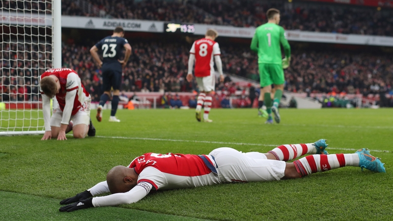 Emile Smith Rowe and Alexandre Lacazette collapse on the turf after a missed chance.