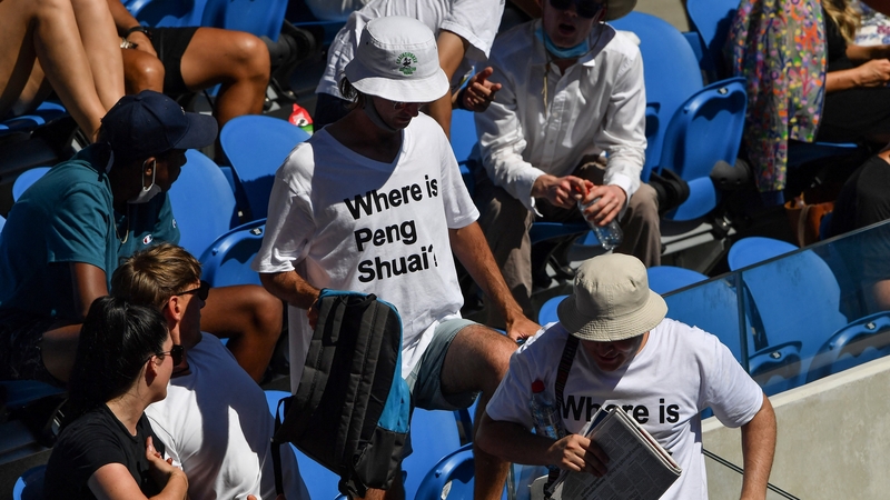 Spectators wearing "Where is Peng Shuai?" T-shirts are pictured in the stands at the Australian Open