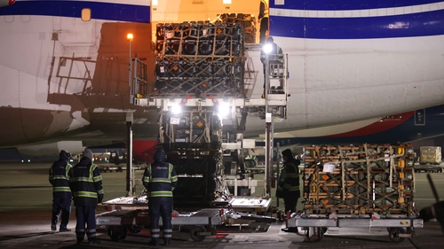 Ground crew unload weapons and other military hardware delivered by the United States military at Boryspil Airport near Kyiv