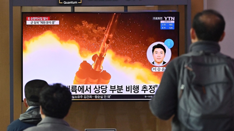 People watch a news broadcast, with file footage of a North Korean missile test, at a railway station in Seoul on Tuesday