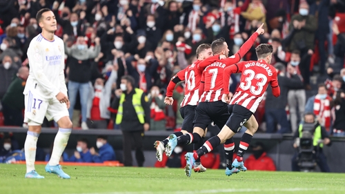 Lucas Vazquez looks dejected as Bilbao players celebrate the late victory