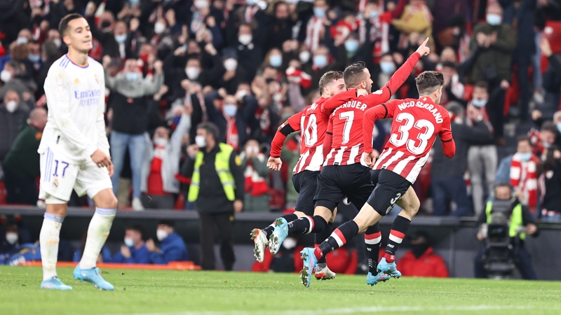 Lucas Vazquez looks dejected as Bilbao players celebrate the late victory