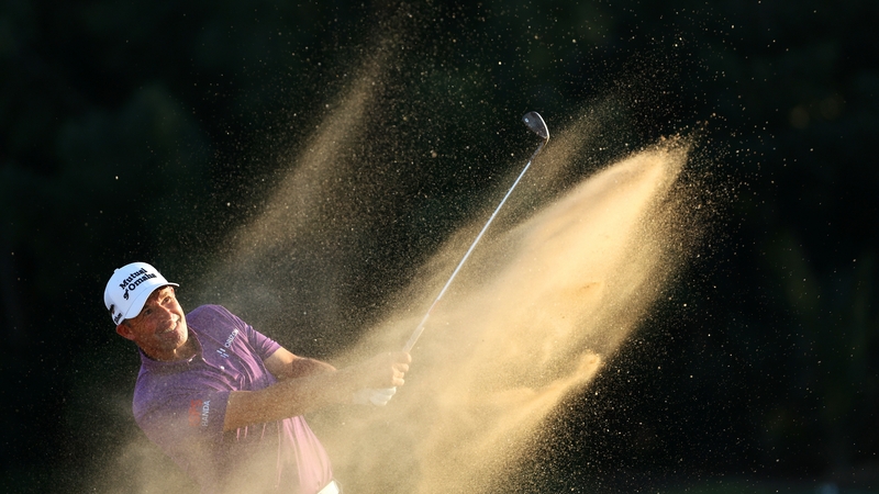 Padraig Harrington plays out of a bunker on the 18th