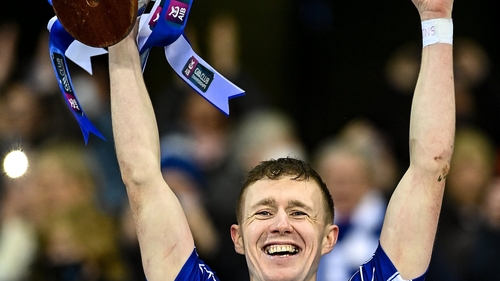 Naas captain Brian Byrne lifts the cup