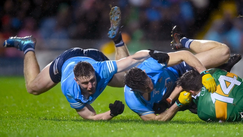 David Clifford tussles on the ground with John Small, left, and David Byrne