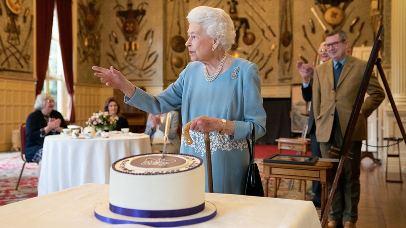 Britain's Queen Elizabeth cuts a cake to celebrate the start of the Platinum Jubilee during a reception yesterday