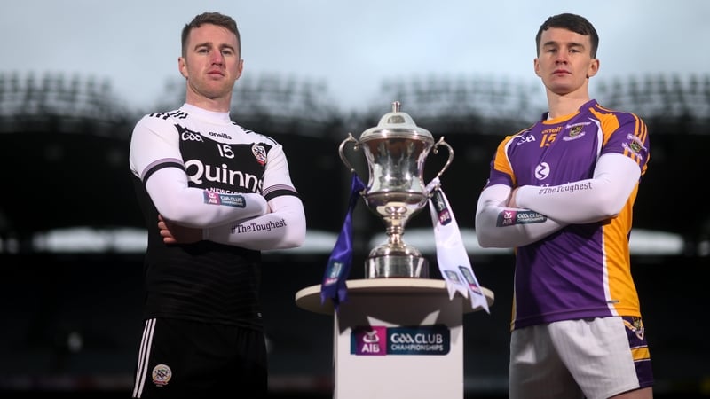 Paul Devlin of Kilcoo (L) and Dara Mullin beside the Andy Merrigan Cup.