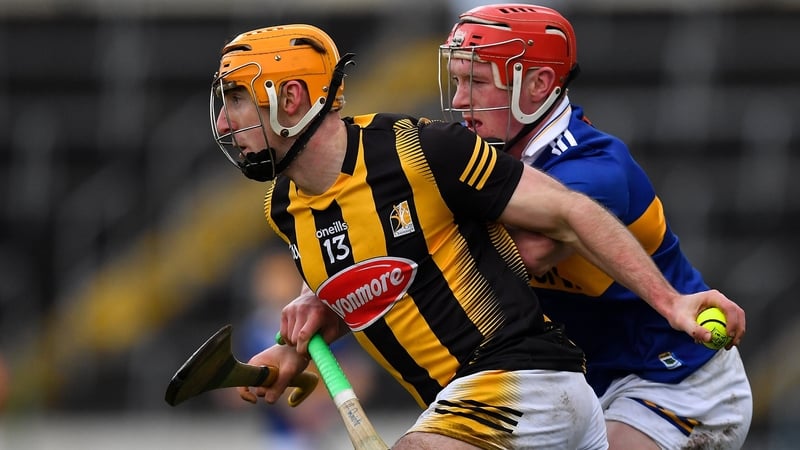 Billy Ryan of Kilkenny holds off Tipp's Dillon Quirke.