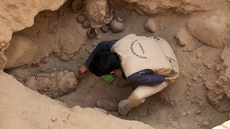 An archaeologist works at the Cajamarquilla archeological site, where 14 mummies were found.