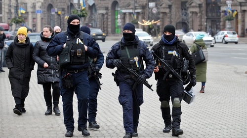 Ukrainian police officers patrol a street in central Kyiv on 16 February