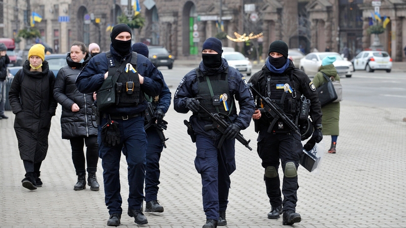 Ukrainian police officers patrol a street in central Kyiv on 16 February