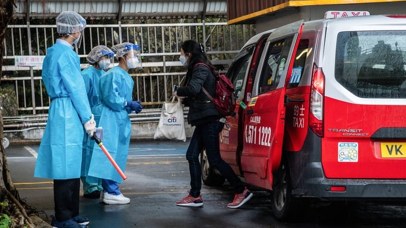 A passenger is greeted by staff at the Shau Kei Wan Designated Covid-19 Clinic in Hong Kong