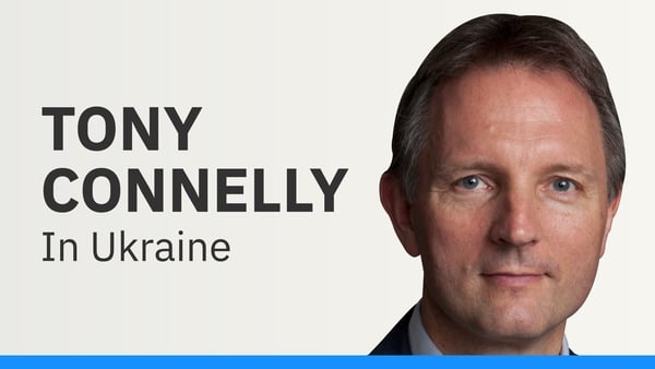 A female utility worker operates at the scene of a Russian strike drone hit on a residential high-rise in Kharkiv, Ukraine