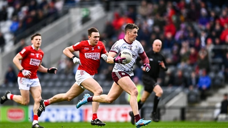Galway's Shane Walsh (R) is chased by Cork's Kevin Flahive
