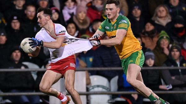 Darragh Canavan of Tyrone has his jersey pulled by Niall O'Donnell