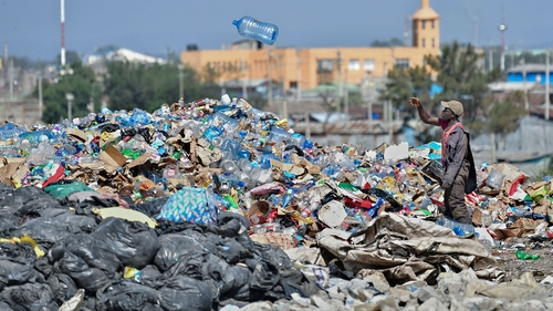 A man picks through plastic waste at the Dandora landfill site in Nairobi, Kenya