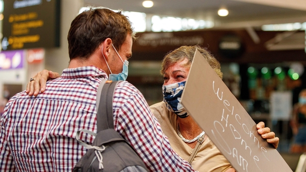Passengers and loved ones reunite in the arrivals hall at Auckland international airport