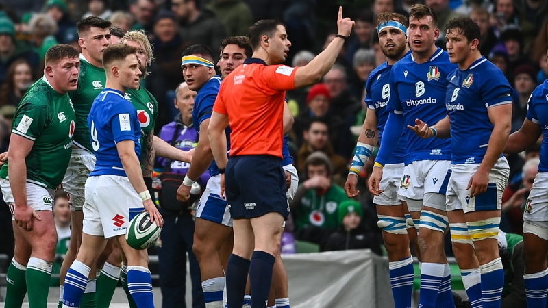 Nika Amashukeli explains to Italy captain Michele Lamaro that he has to play with 13