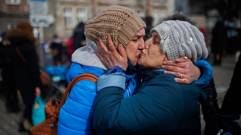 A mother and daughter kiss upon arrival from Ukraine at the Przemysl train station in Poland