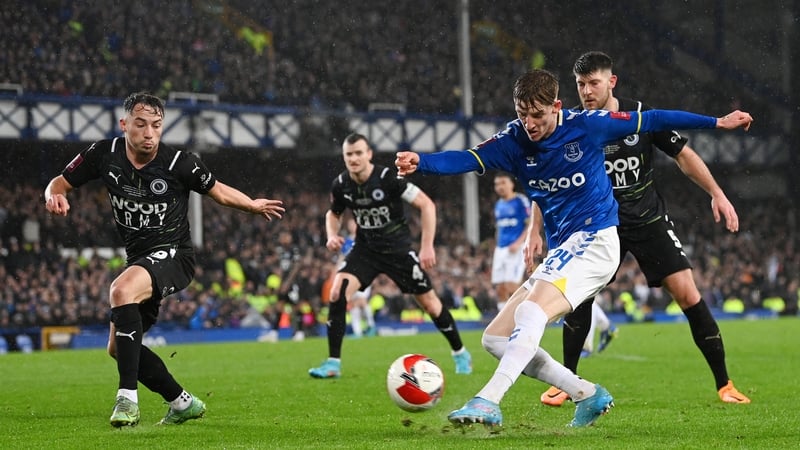 Anthony Gordon of Everton shoots on target while challenged by Boreham Wood's Kane Smith.