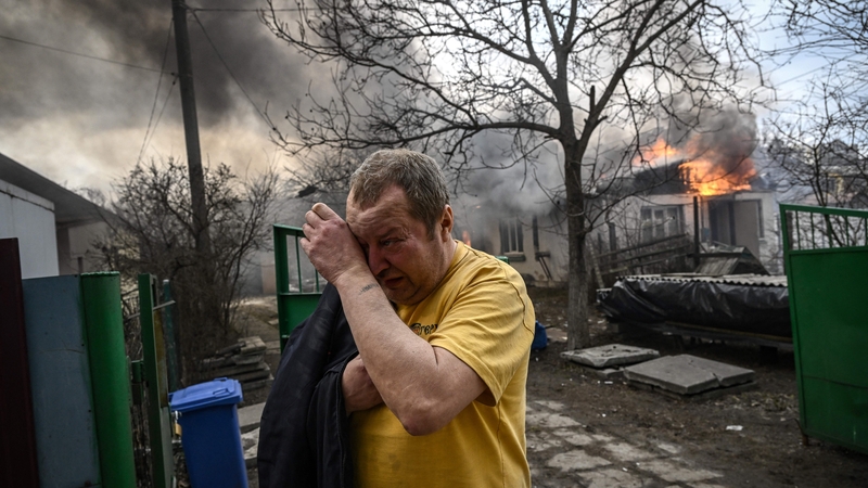 A man reacts in front of his burning home after it was hit by shelling in the city of Irpin, outside Kyiv (file pic)