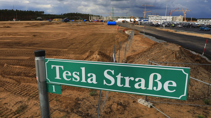 A 'Tesla Street' sign stands near a plot of land at the Tesla gigafactory construction site in Gruenheide in Germany