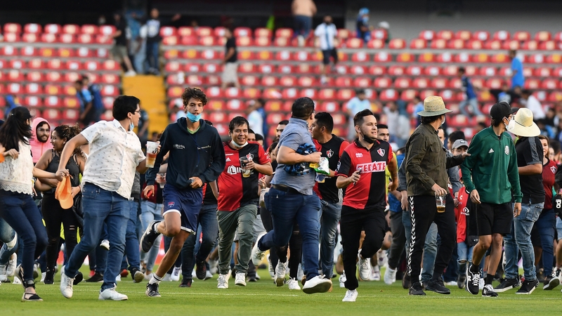 Supporters of both teams took to the field at Estadio Corregidora