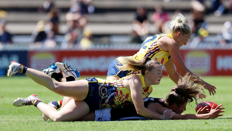 Ailish Considine of the Crows tackles Mikala Cann of the Magpies