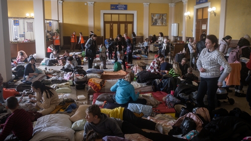 People flock to the train station in Lviv in a bid to leave Ukraine