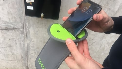 Students place their phones in specialised pouches which are then secured by magnetic lock when they enter the school