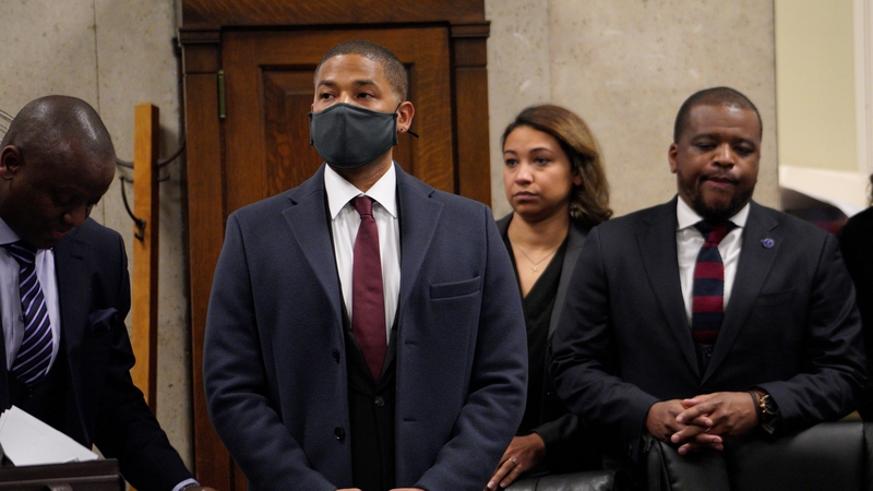 Jussie Smollett (wearing a facemask) was indicted for staging a hate crime