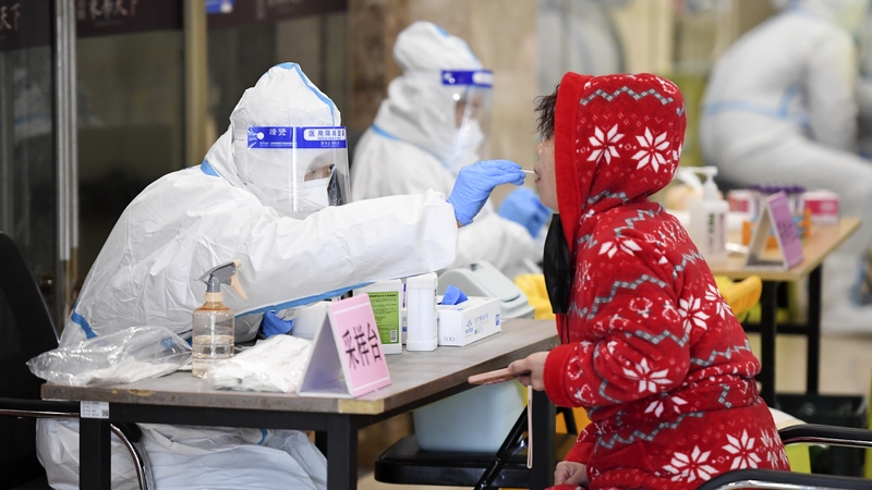 A medical worker takes a Covid swab sample from a local resident in Changchun, Jilin Province of China