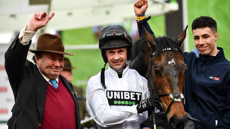 Jockey Nico de Boinville (C), trainer Paul Nicholls (L) and handler Jaydon Lee celebrate with Constitution Hill