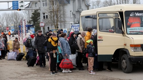 People fleeing the conflict in Ukraine cross a Moldova-Ukraine border checkpoint near the Moldovan town of Palanca