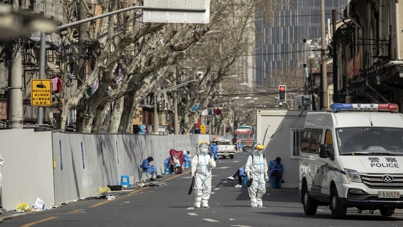 Workers disinfect a neighbourhood under Covid lockdown in Shanghai, China
