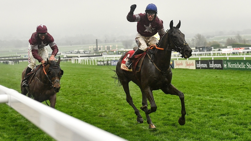 Jockey Jack Kennedy, on Delta Work, celebrates winning the Glenfarclas Cross Country Chase from Tiger Roll, with Davy Russell up