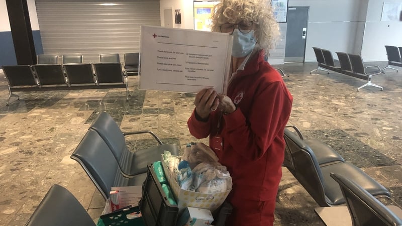 Irish Red Cross volunteer Aebh O'Callaghan preparing a box of personal hygiene items for Ukrainian refugees arriving at Shannon Airport