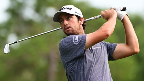 Davis Riley tracks the ball after playing his tee shot on the 17th hole