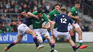 James Culhane of Ireland is tackled by Christian Townsend of Scotland