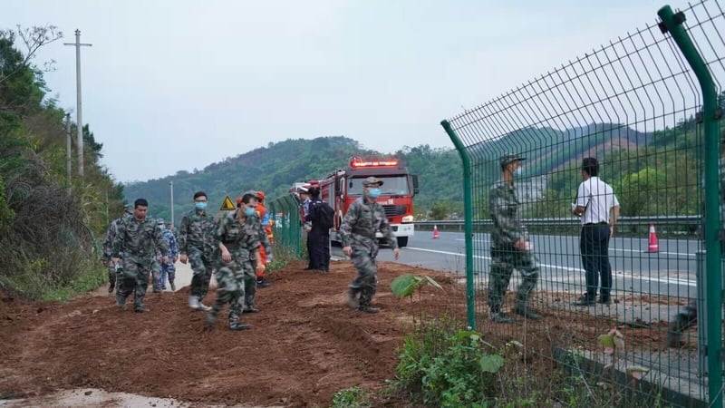 Rescuers work at the site of the plane crash